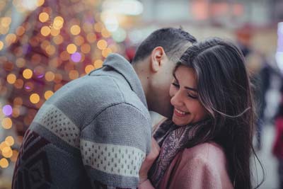 A picture of a man kissing his beautiful Medellin girlfriend